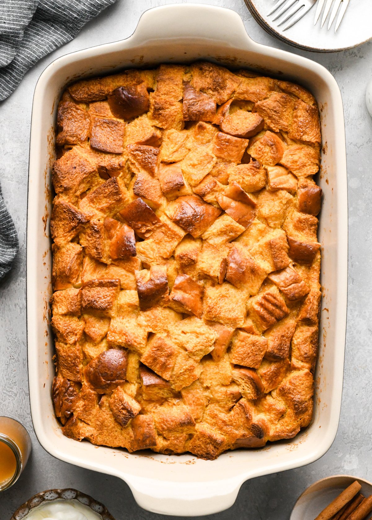 pumpkin bread pudding in a baking dish after baking on a gray surface
