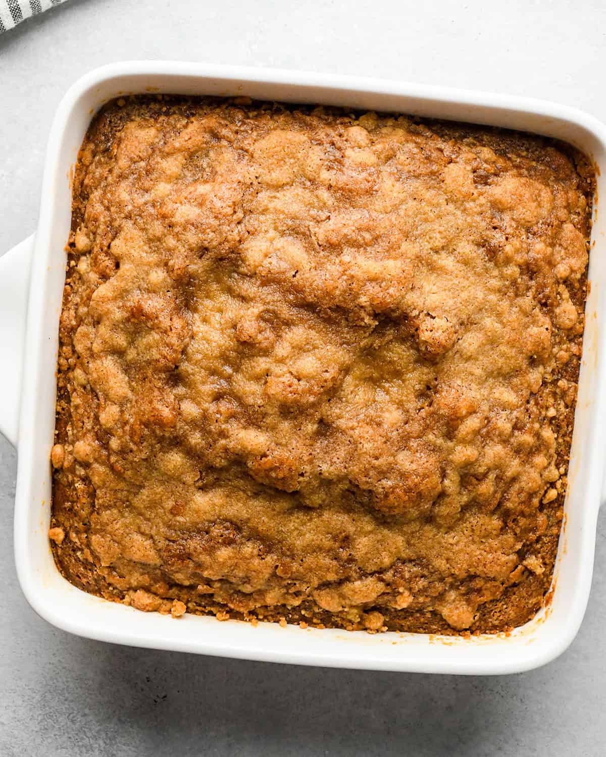 Pumpkin Coffee Cake in a white baking dish on a gray surface after baking