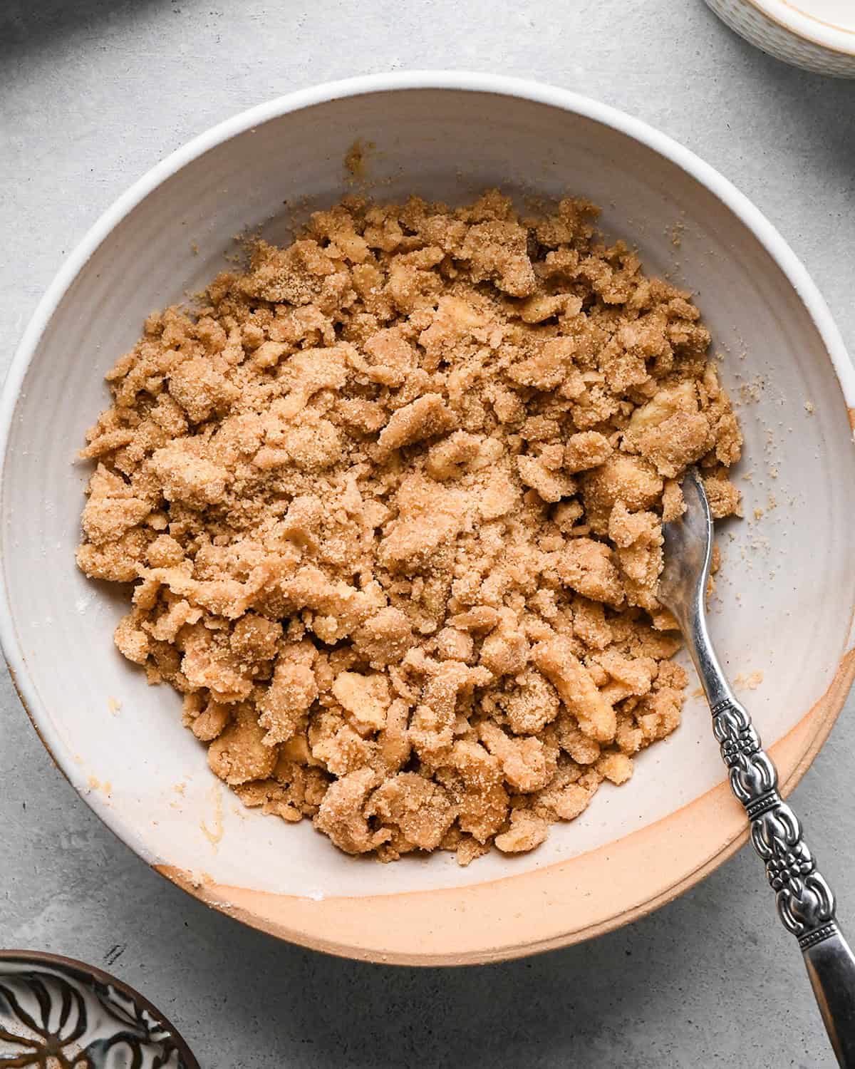 Pumpkin Coffee Cake final crumb topping in a bowl with a fork