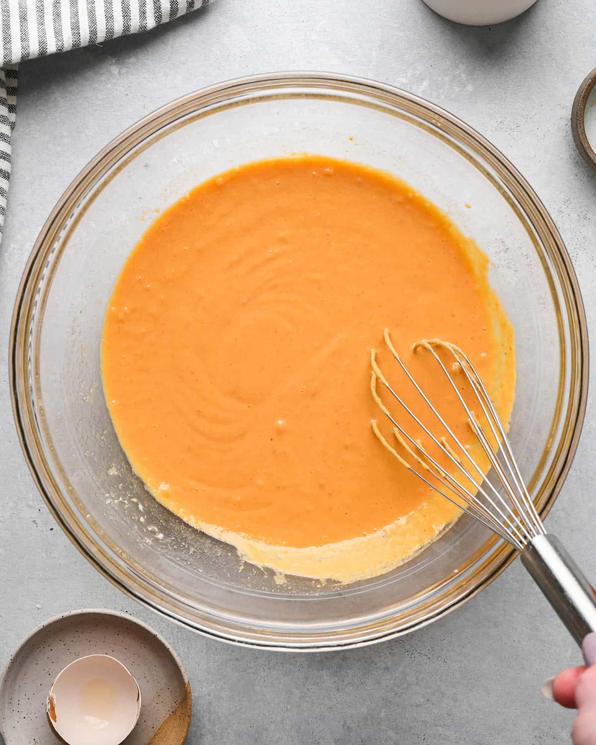 making Pumpkin Coffee Cake - wet ingredients whisked in a glass bowl