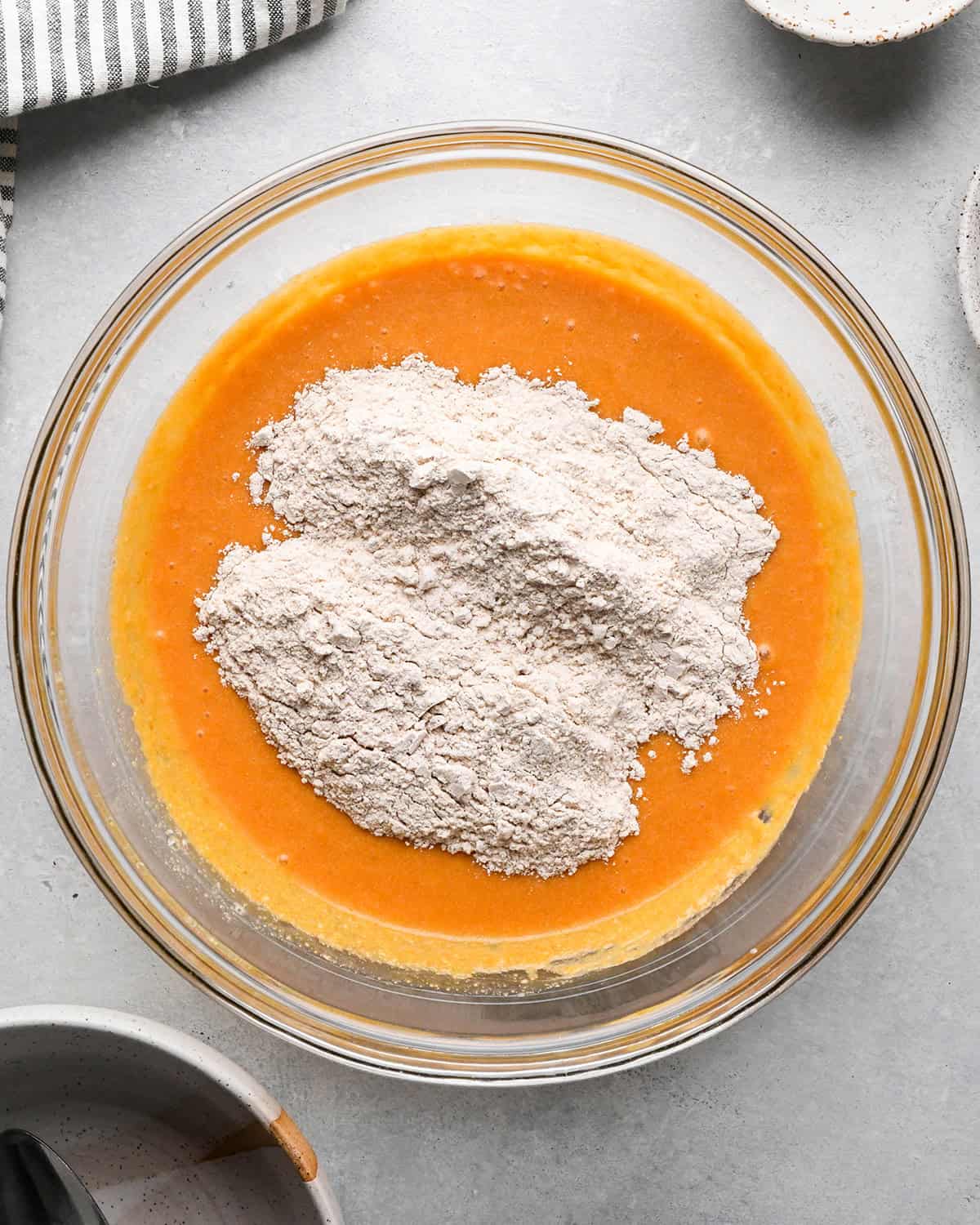 making Pumpkin Coffee Cake - dry ingredients added to wet in a bowl before mixing