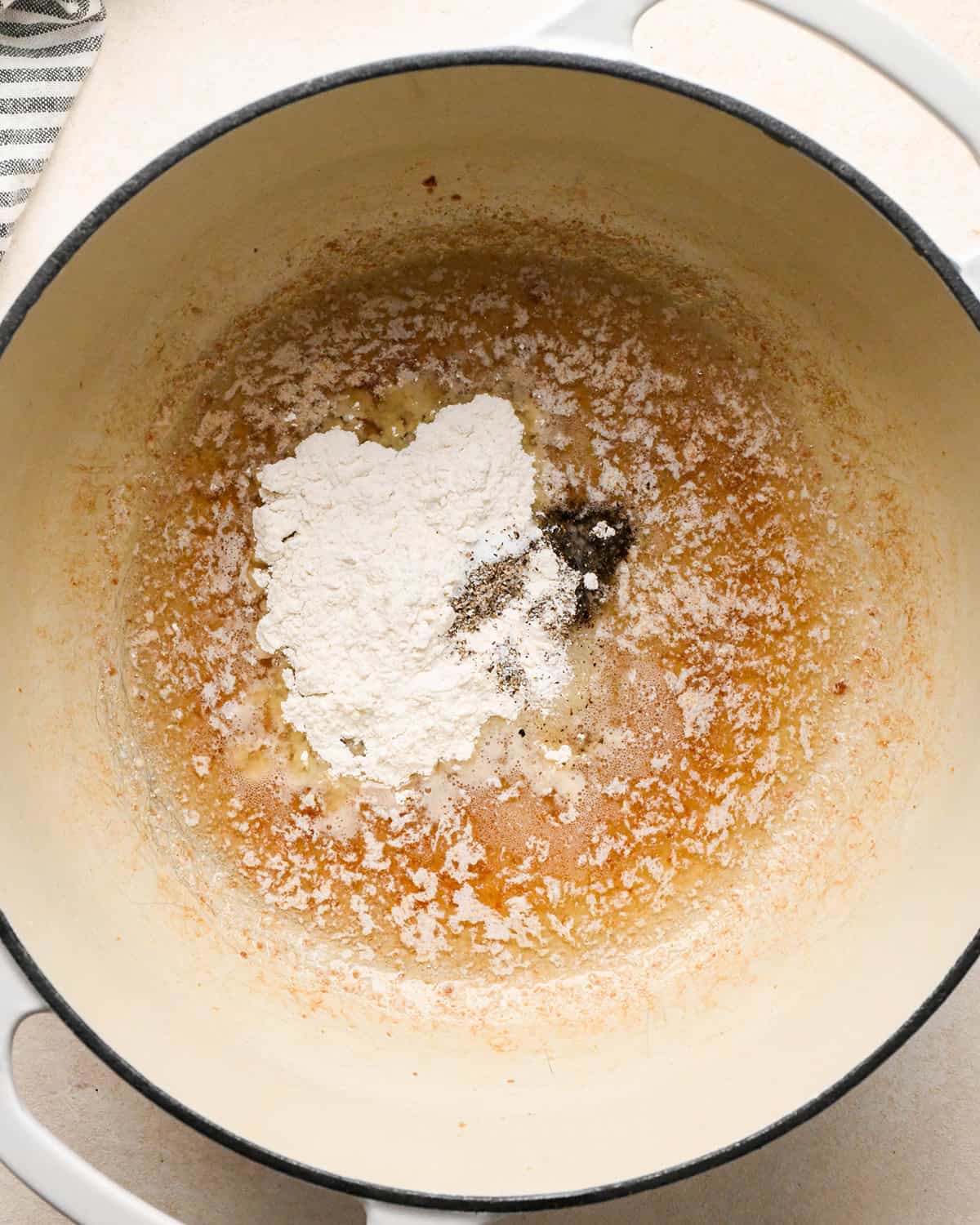 flour salt and pepper added to the bacon grease and melted butter in a white pot to make bacon mac and cheese before mixing