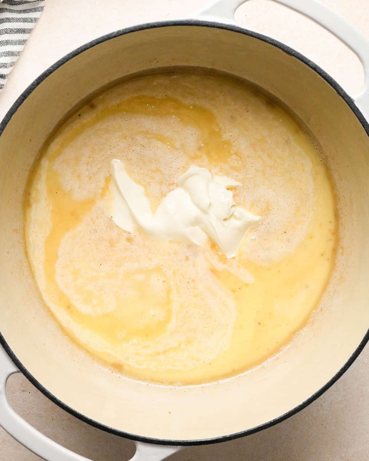 sour cream and milk added to the flour and bacon grease mixture to make bacon macaroni and cheese before whisking