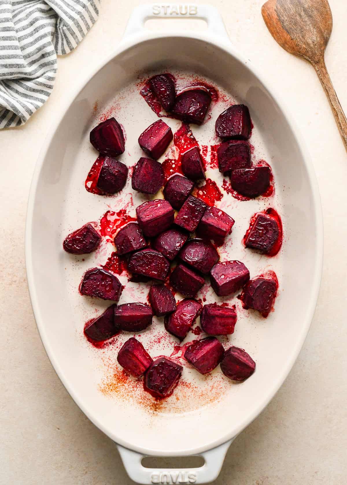 beets in a white, oval ceramic baking dish after baking to be used in a beet salad