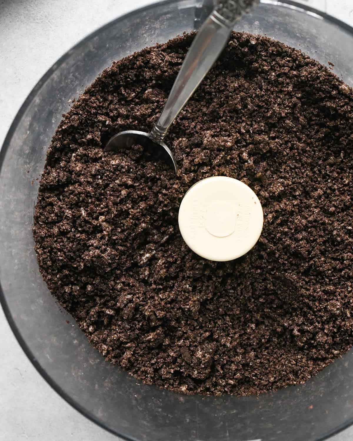 oreo crumbs in a food processor fitted with the "S" blade with a spoon to make the oreo crust for chocolate peanut butter pie