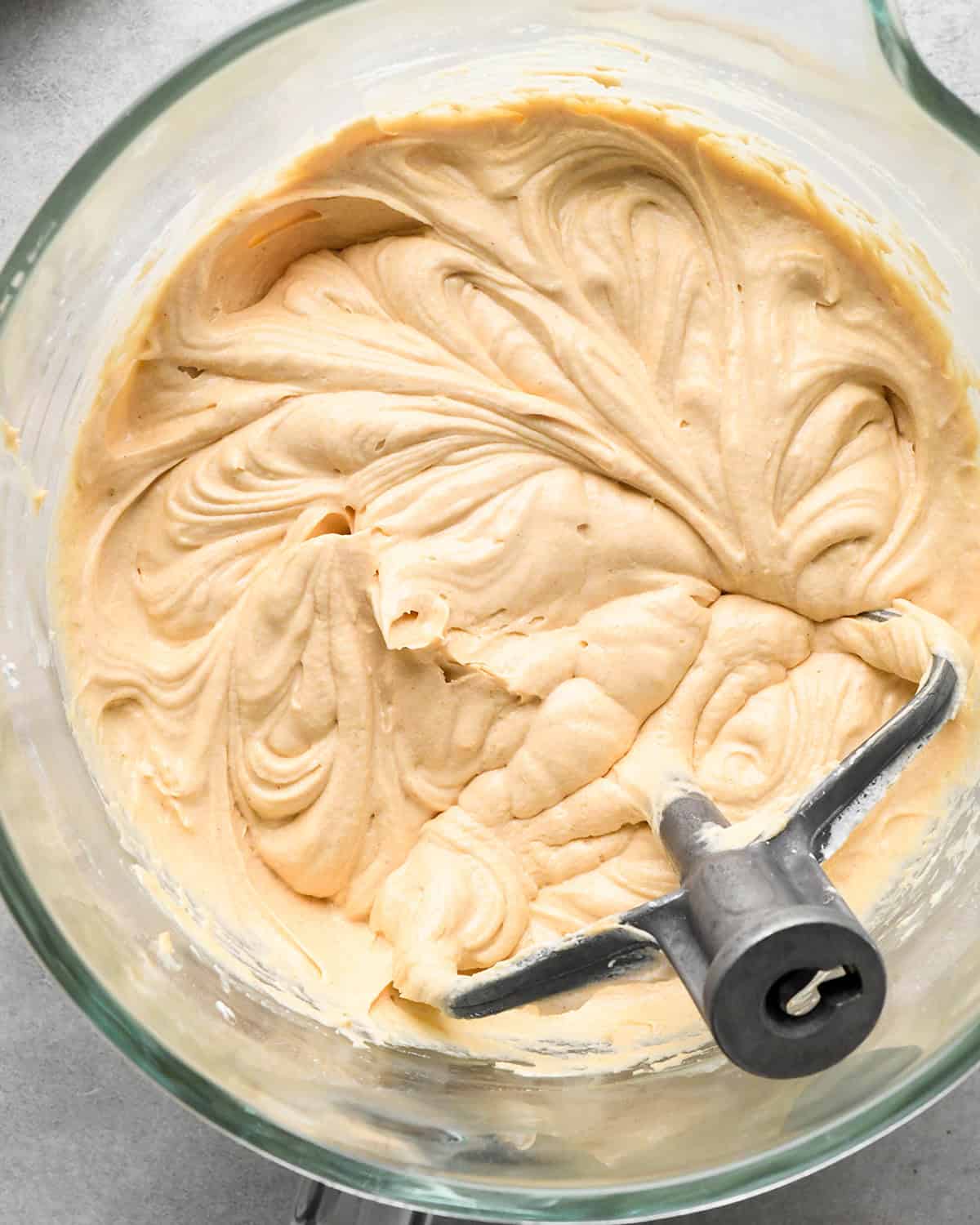 the peanut butter filling for chocolate peanut butter pie in a glass mixing bowl with the paddle attachment in the mixture