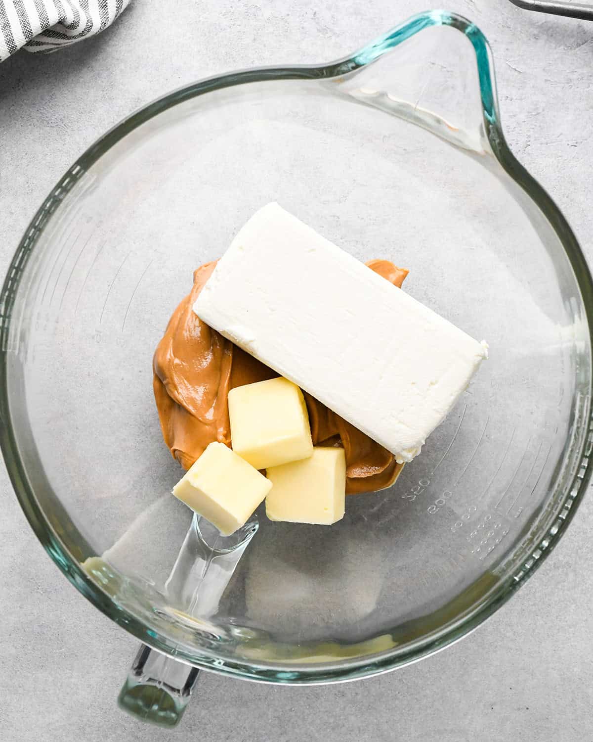 cream cheese, butter and peanut butter in a glass mixing bowl before beating making chocolate peanut butter pie