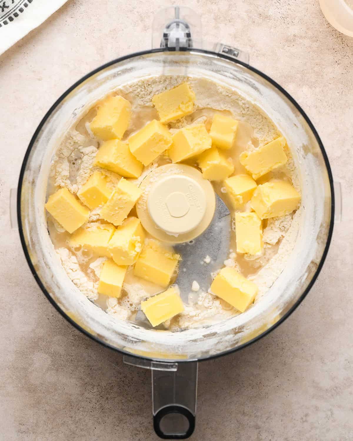 butter and water added to flour mixture in a food processor before mixing making dutch apple pie crust