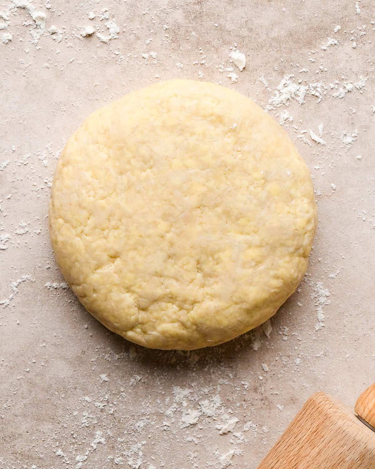 a disc of pie crust on a floured surface after it has been chilled before rolling to make this dutch apple pie recipe