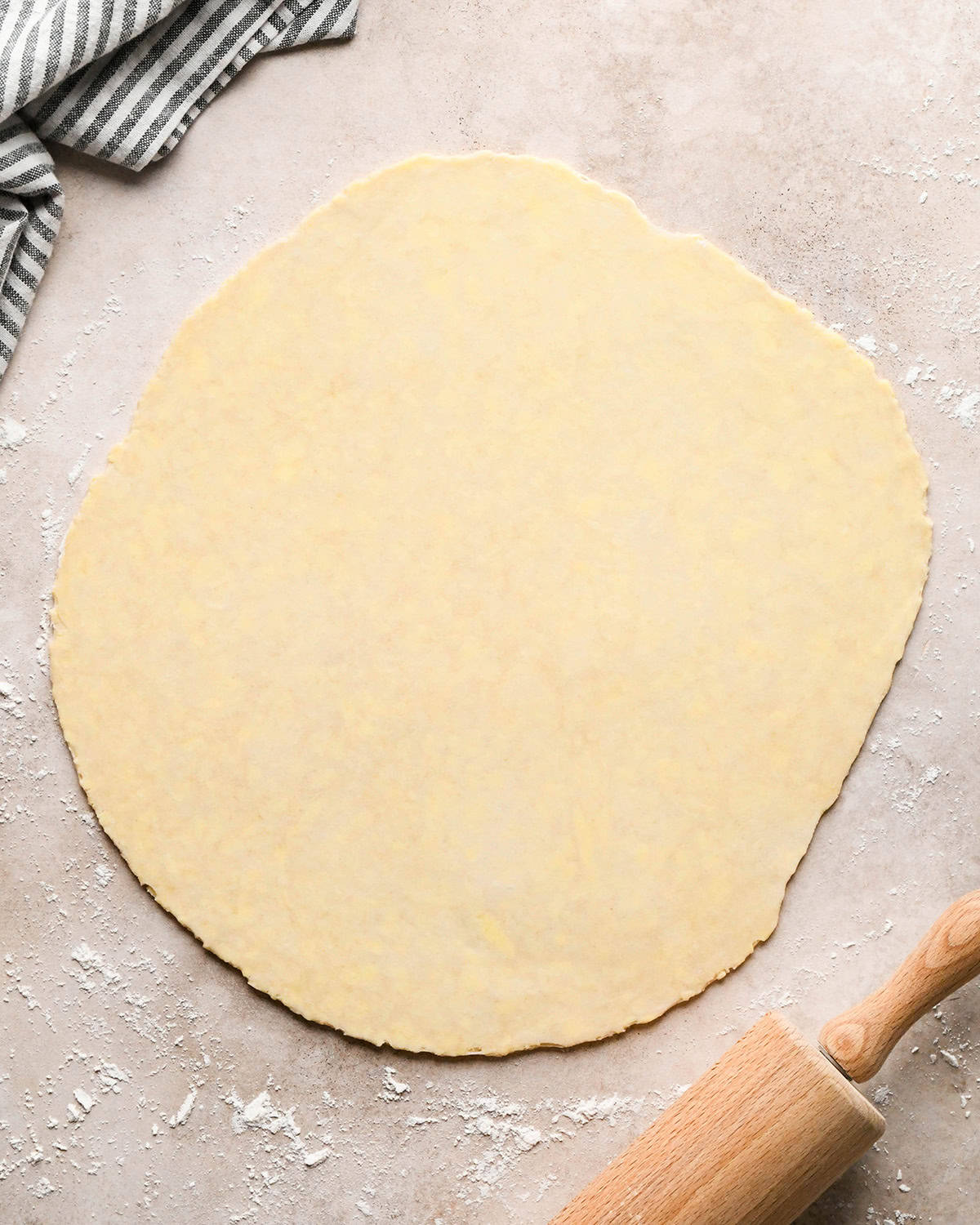 a rolled out pie crust on a floured surface to make this dutch apple pie recipe