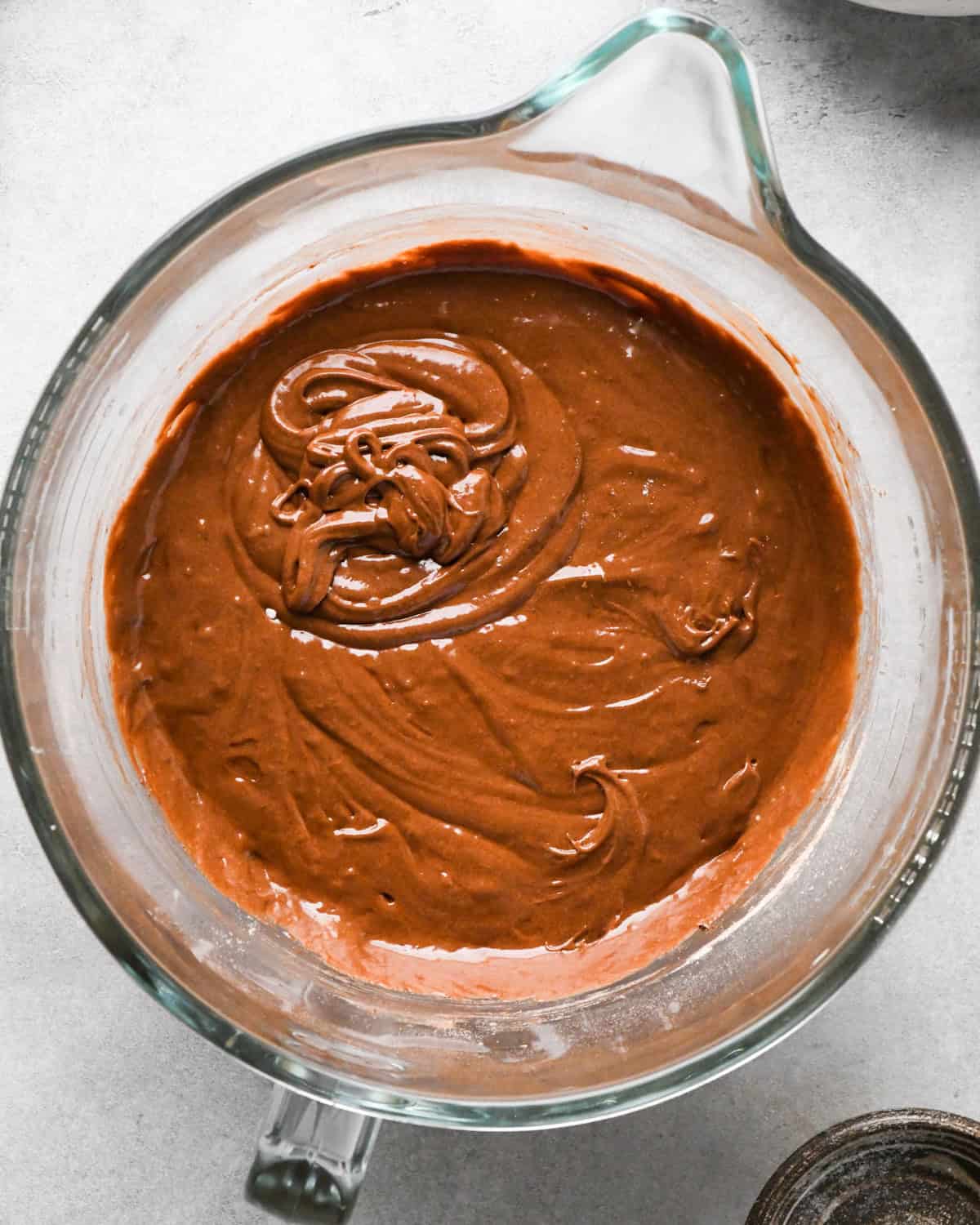 Making skillet brownies - dry ingredients and wet ingredients are mixed together in a clear measuring bowl and mixed together