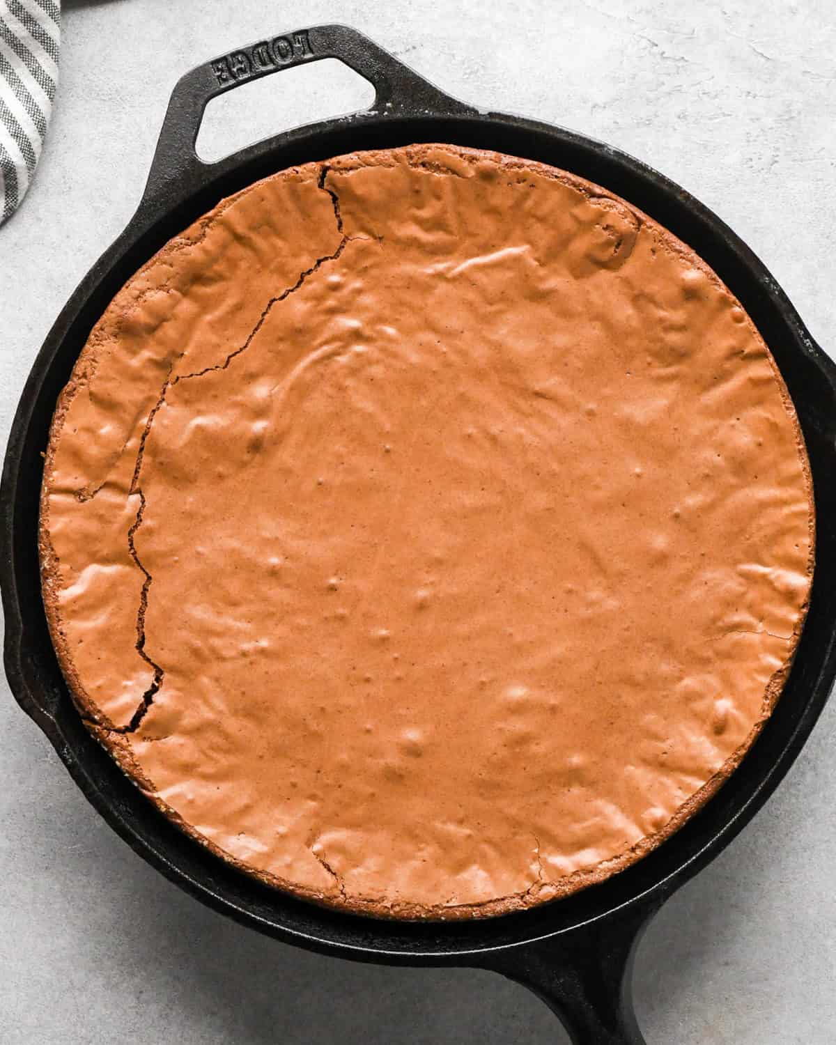Making skillet brownies - overhead photo of brownies baked in a cast iron skillet and sitting on a countertop
