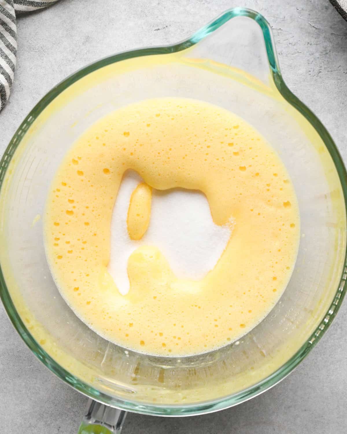 Making skillet brownies - 3 eggs cracked into a clear measuring bowl and whisked together