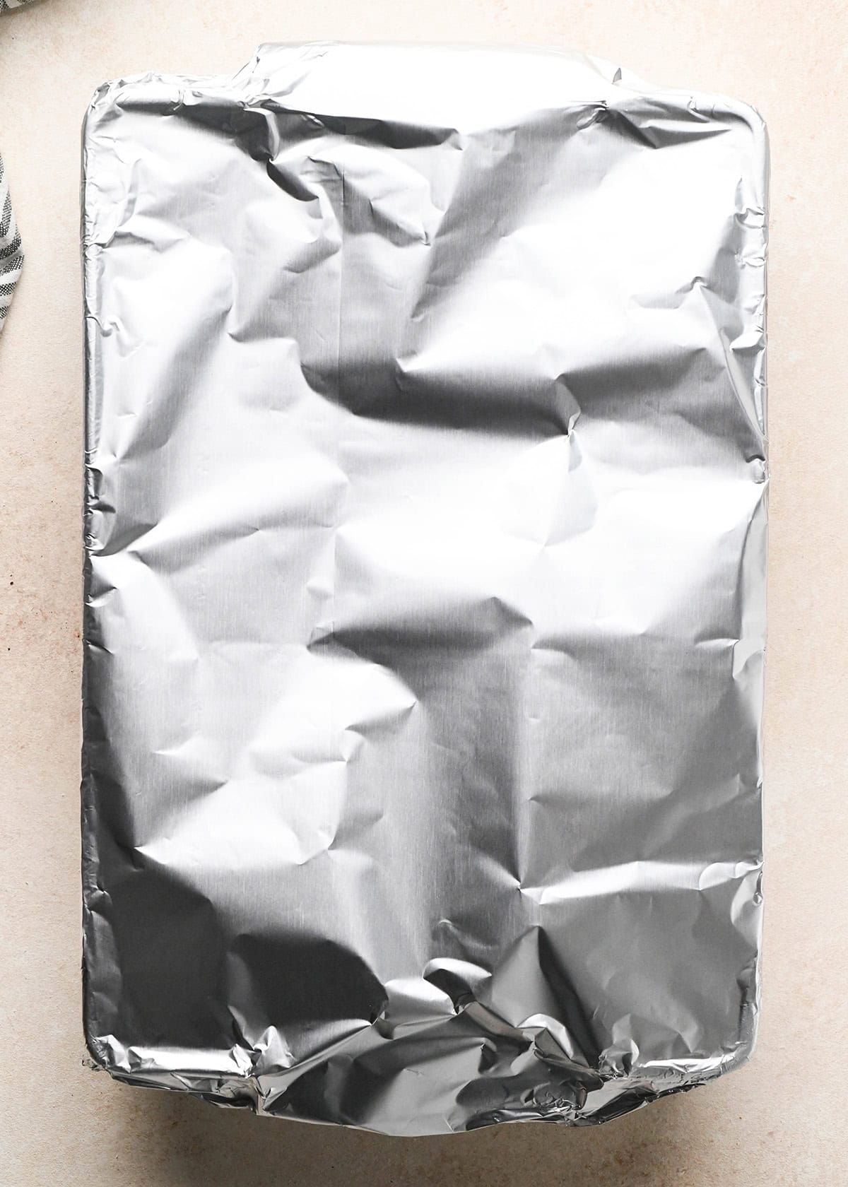 making sweet potato gratin - baking dish covered in aluminum foil 