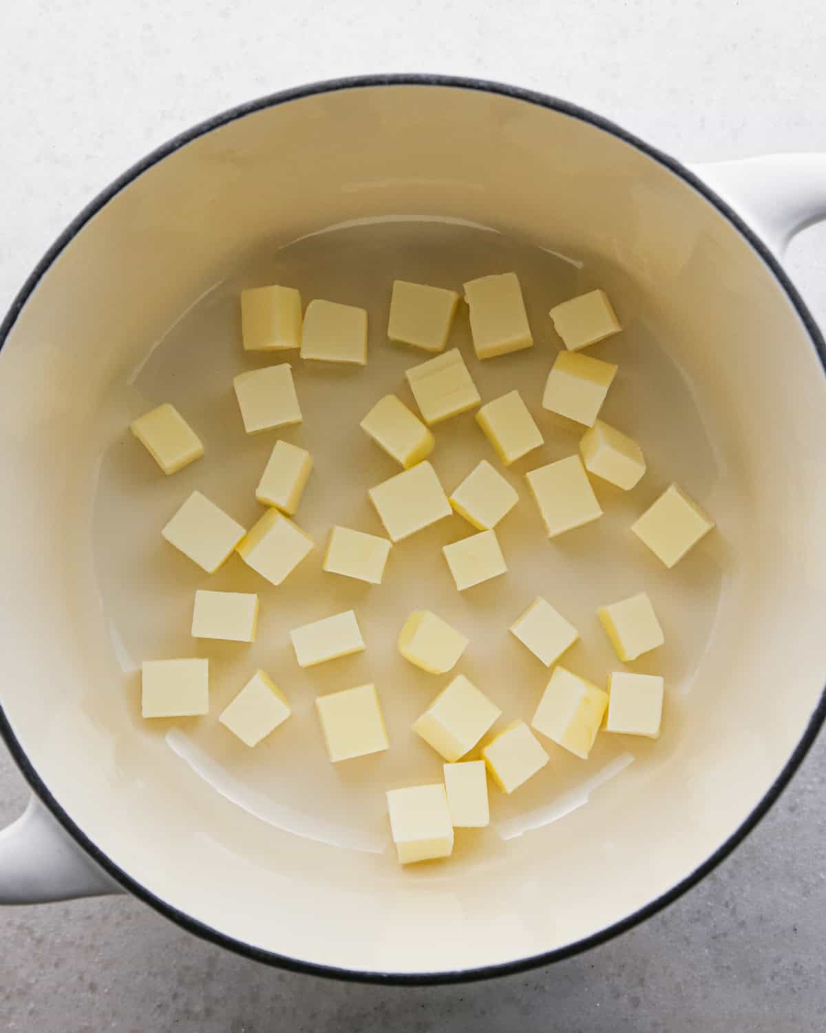 Making brown butter oatmeal cookies - overhead photo of cubes of butter placed in a pot.
