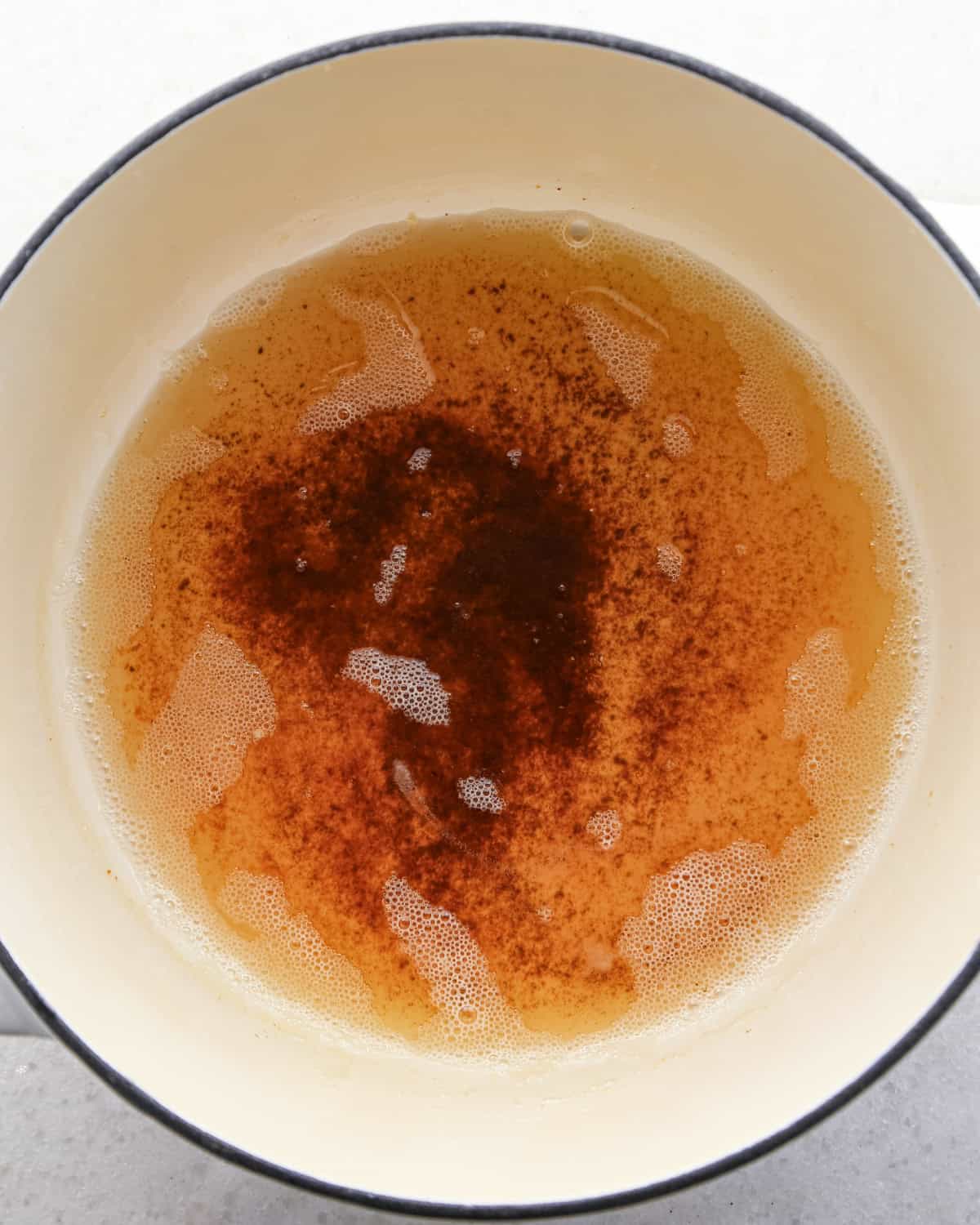 Making brown butter oatmeal cookies - overhead photo of butter melted in a pot and browned.
