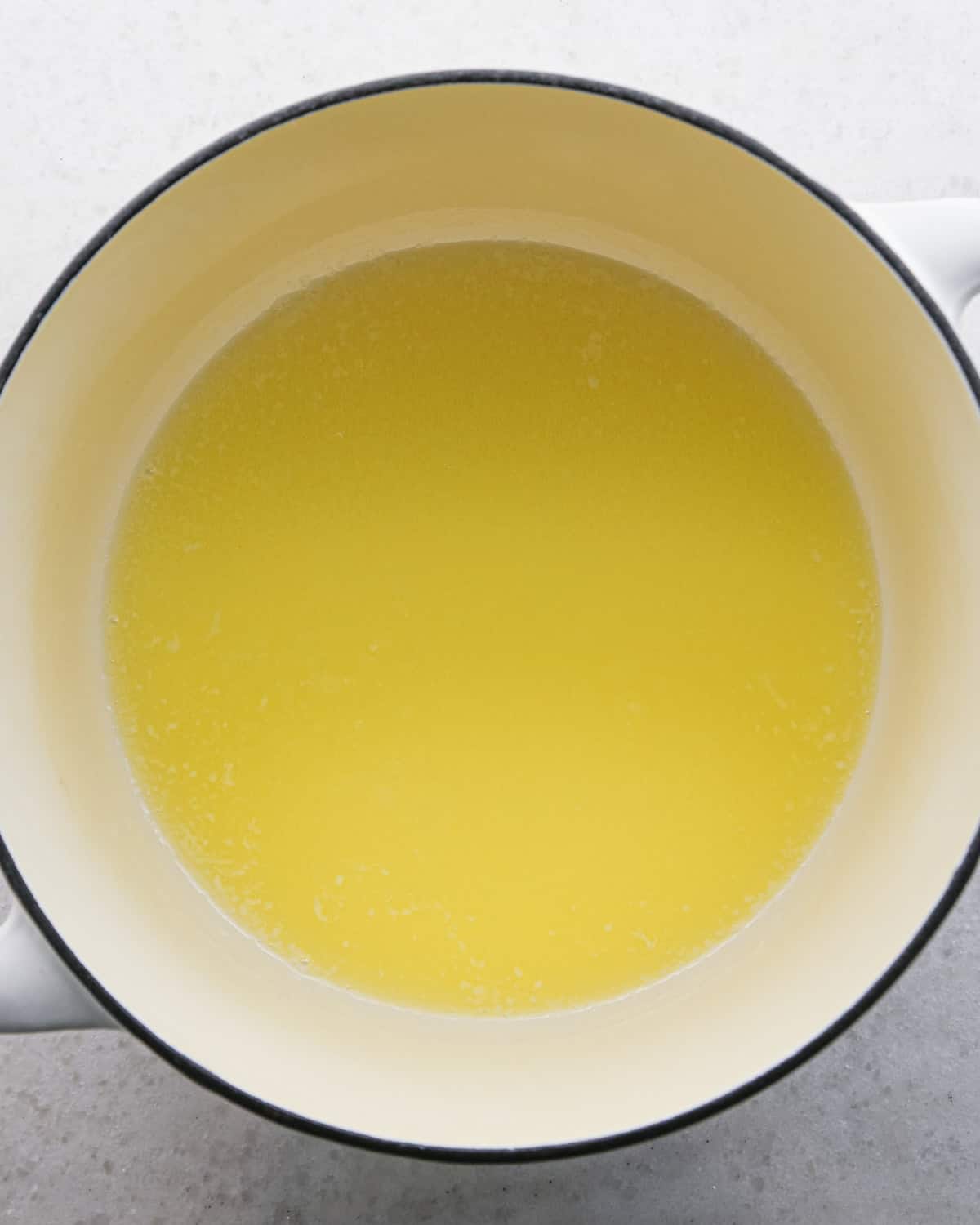 Making brown butter oatmeal cookies - overhead photo of butter melted in a pot.