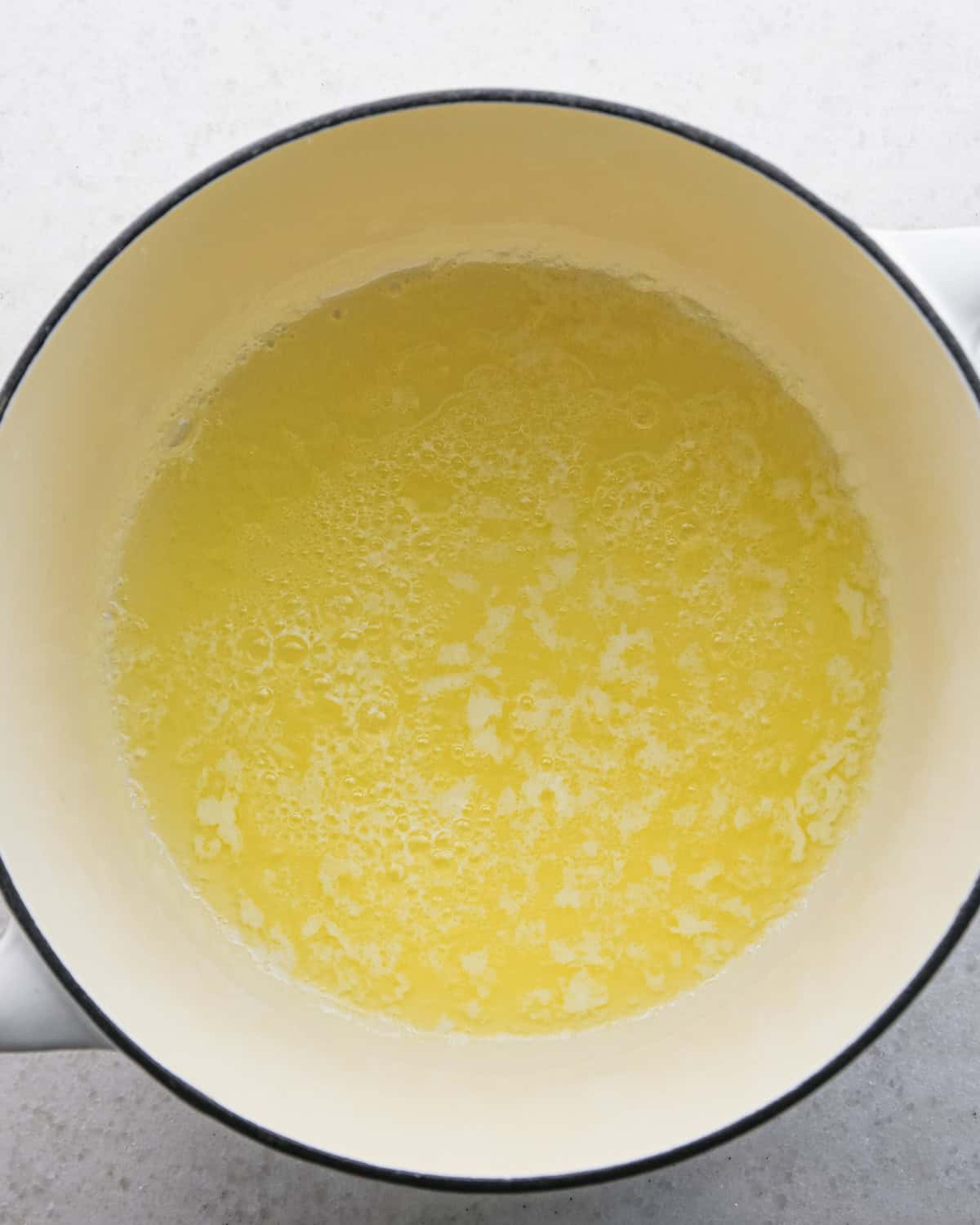 Making brown butter oatmeal cookies - overhead photo of butter melted in a pot.
