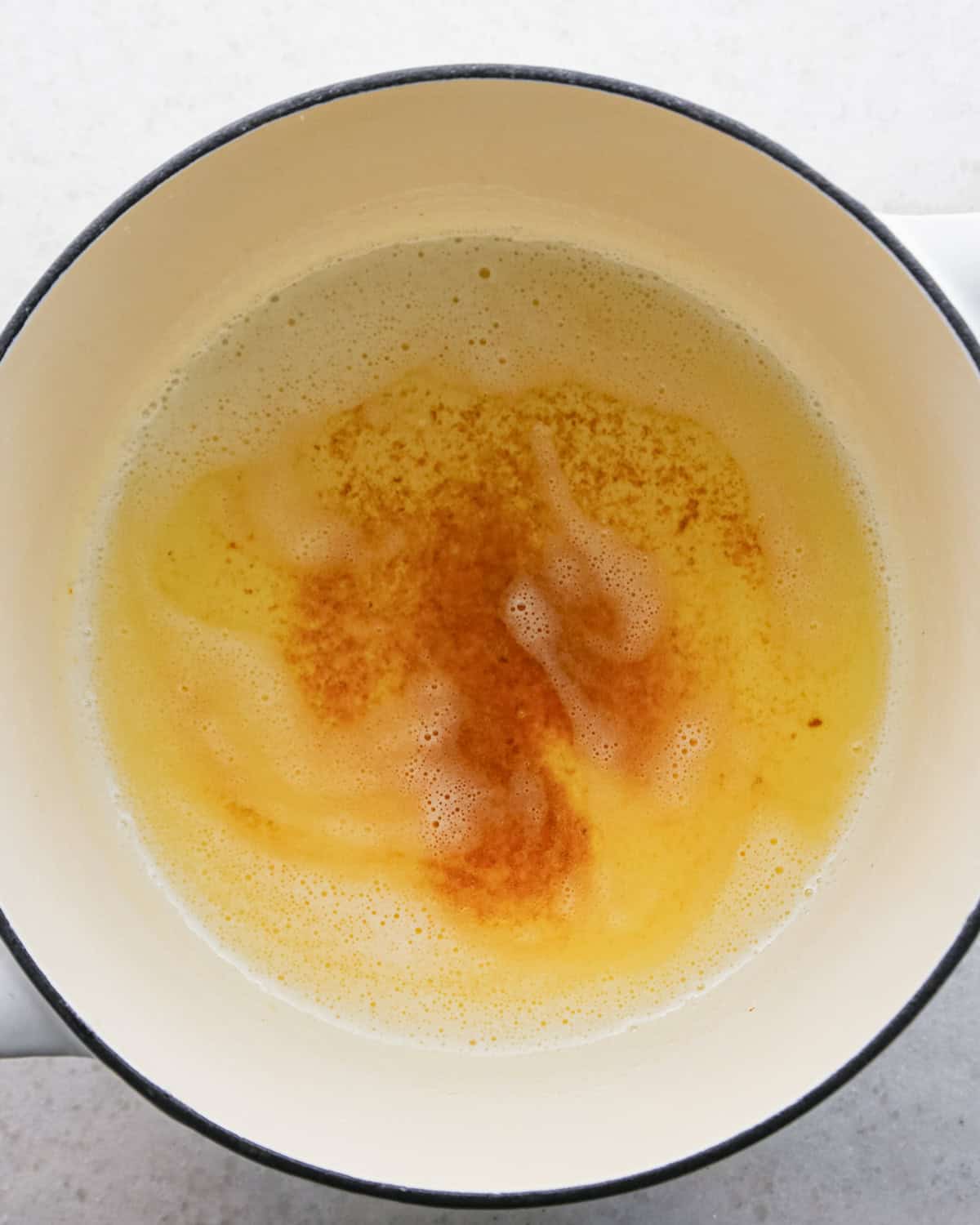 Making brown butter oatmeal cookies - overhead photo of butter melted in a pot and browning.