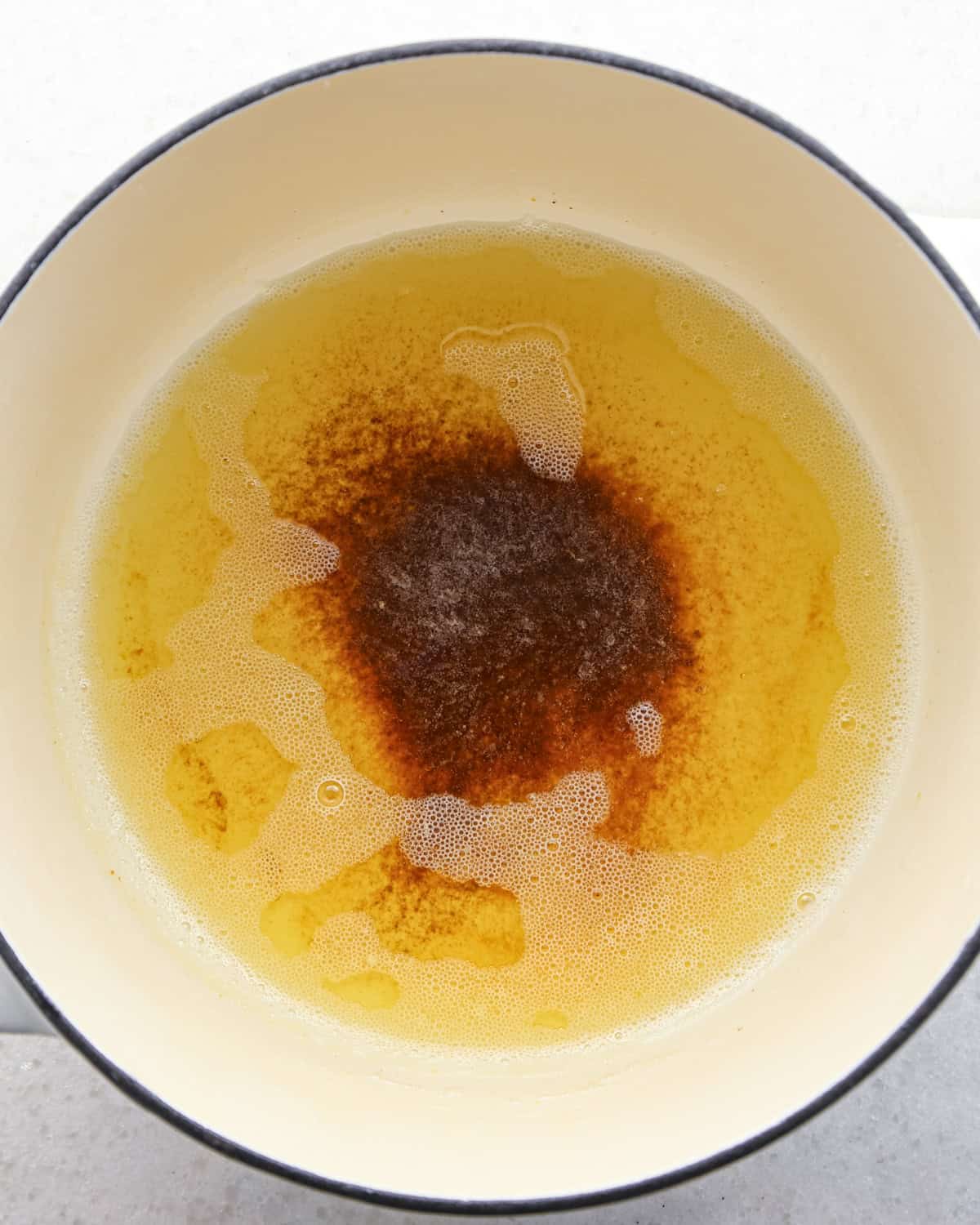 Making brown butter oatmeal cookies - overhead photo of butter melted in a pot and browning.
