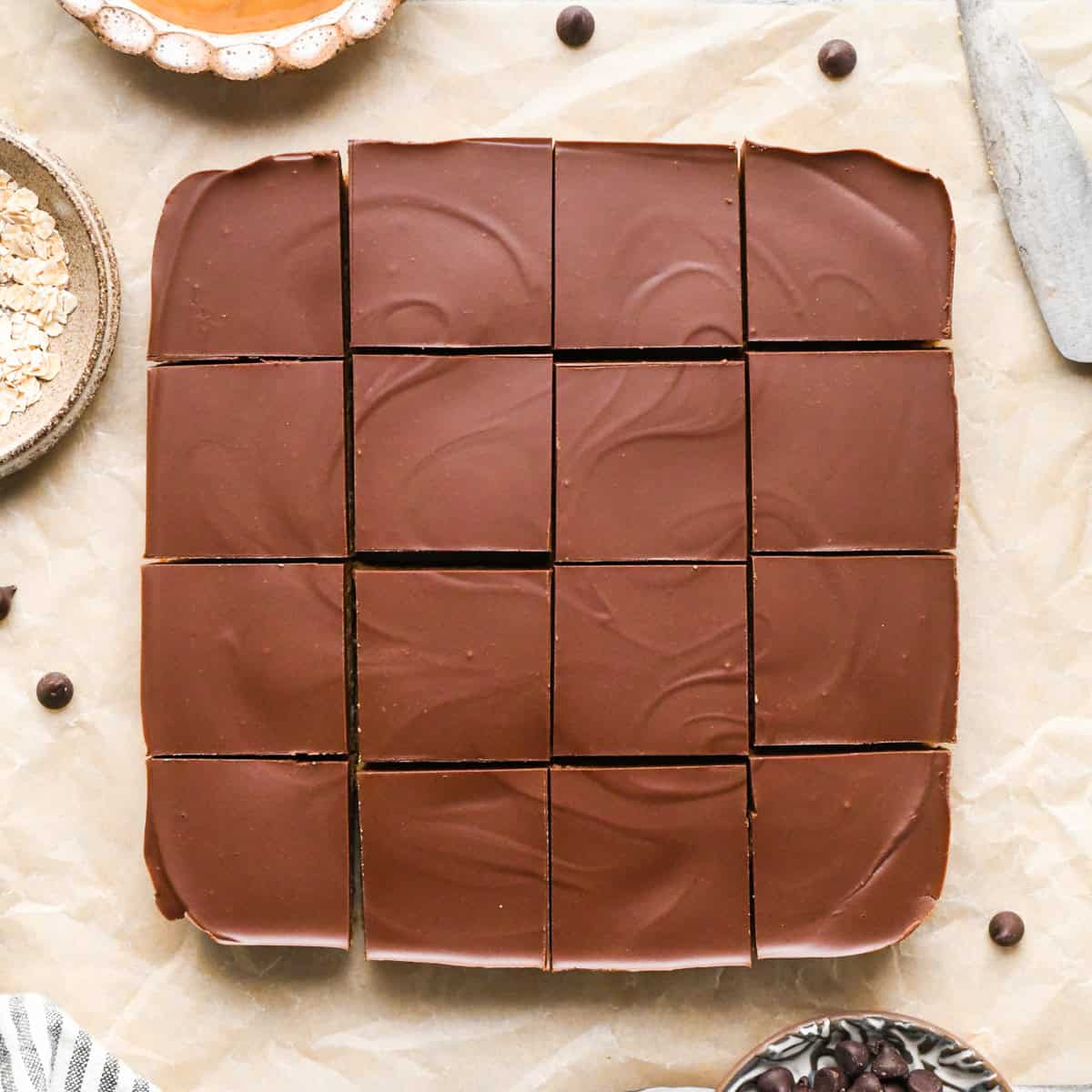 Overhead photo of peanut butter oatmeal bars with a chocolate peanut butter topping, cut into squares and ready to serve.