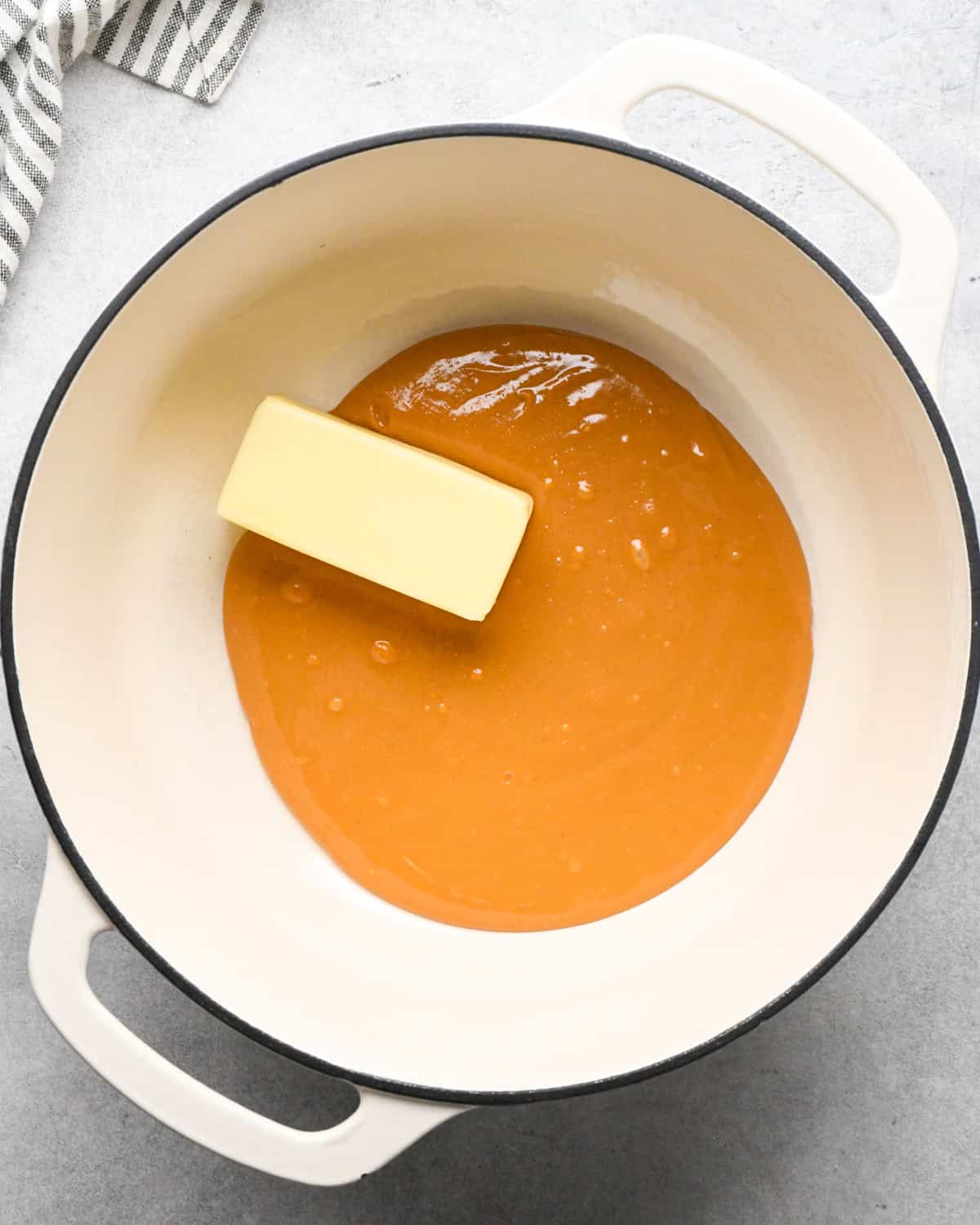 Making peanut butter oatmeal bars - overhead photo of butter and peanut butter being melted in a pot.