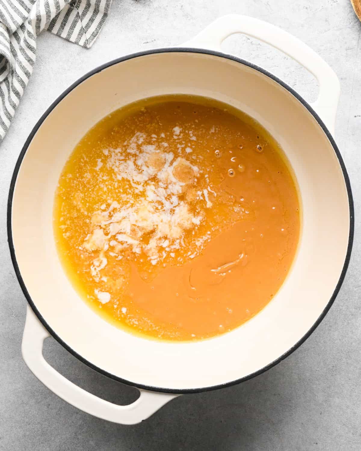 Making peanut butter oatmeal bars - butter and peanut butter melted in a pot.