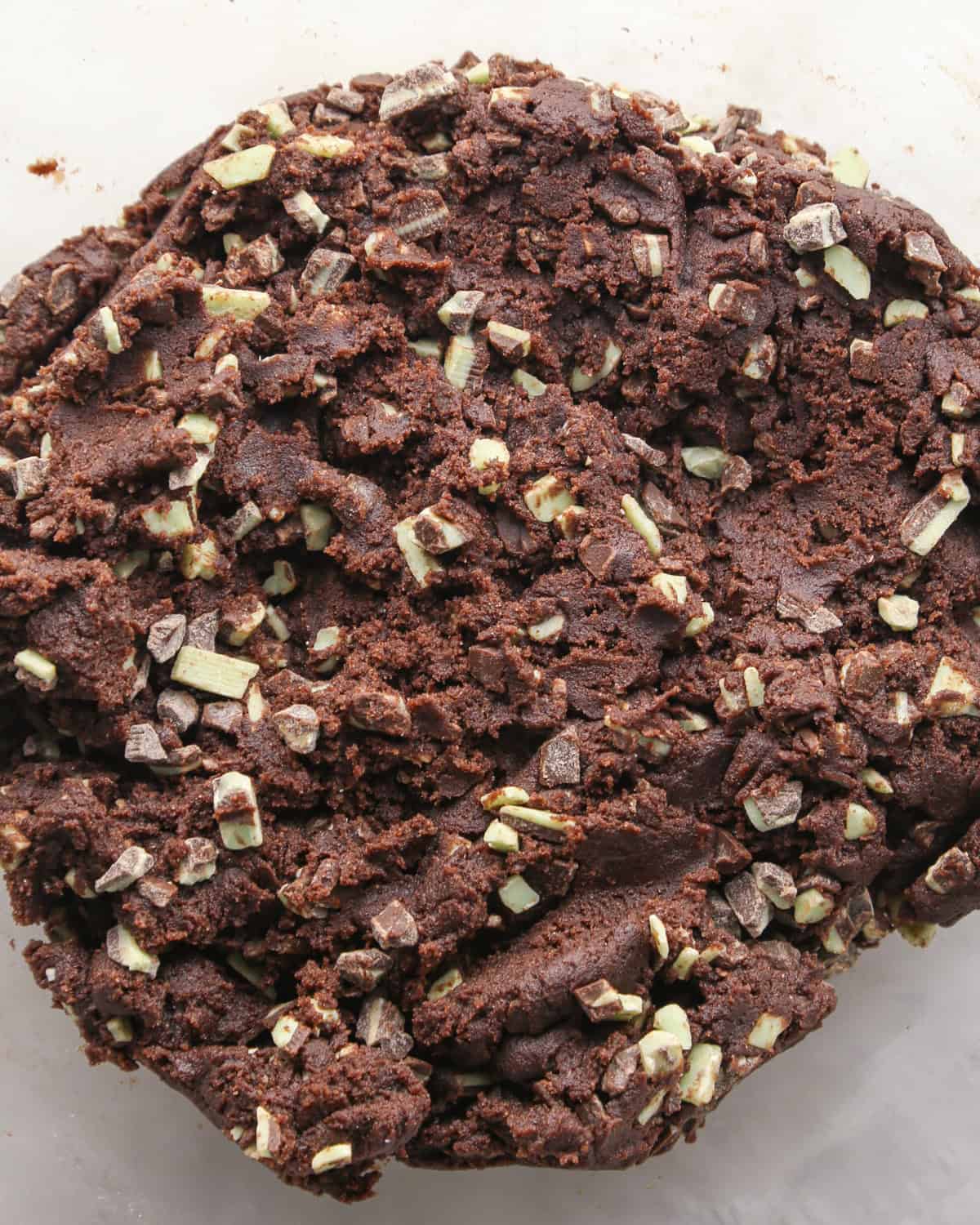 Making chocolate mint cookies - overhead photo of completed cookie dough with mint baking chips mixed in.