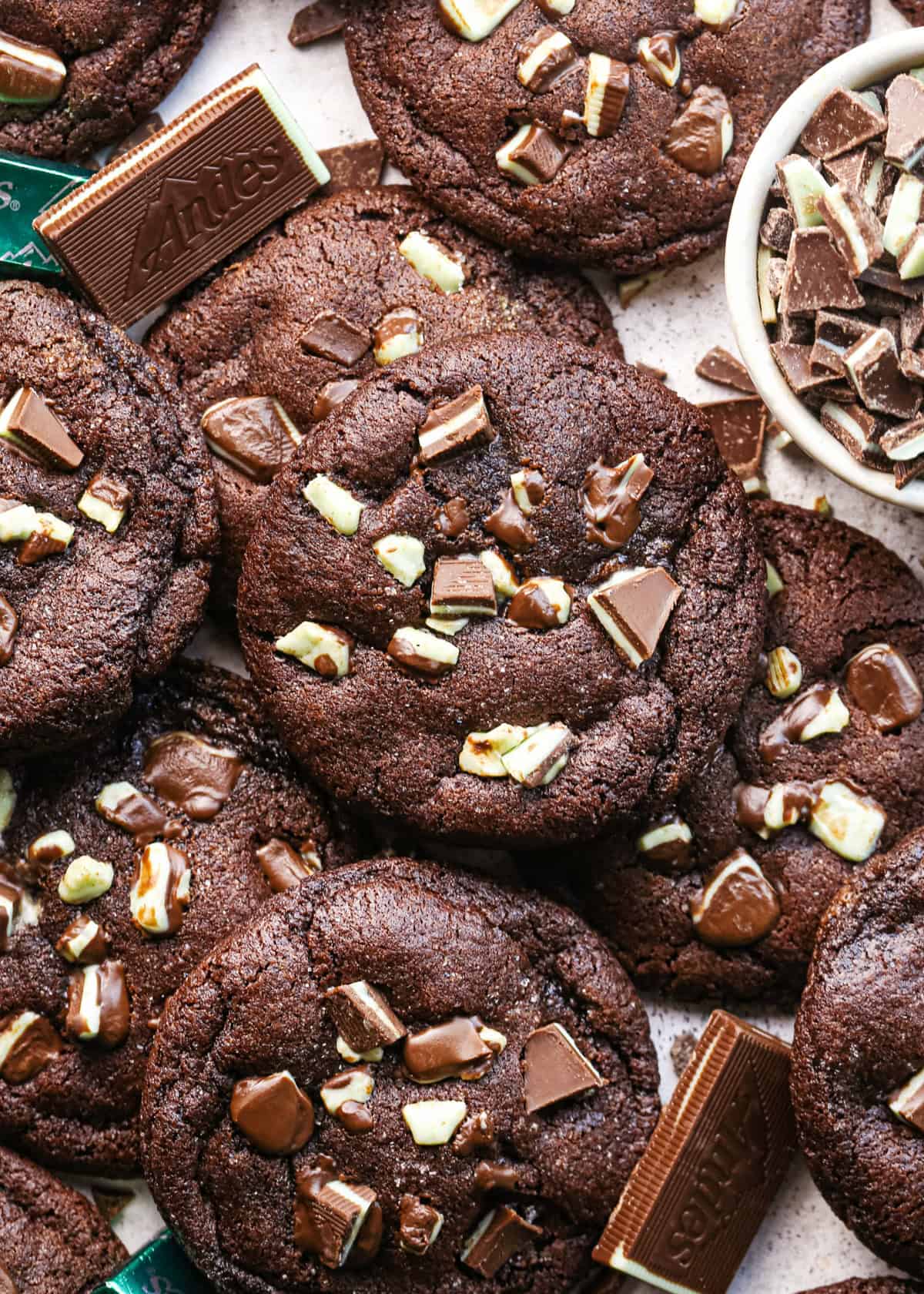 Overhead photo of chocolate mint cookies baked and ready to serve, surrounded by additional mint chocolate pieces.