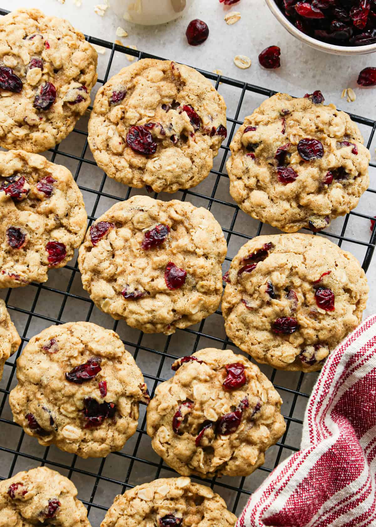 Making cranberry oatmeal cookies - overhead photo of 12 cranberry oatmeal cookies baked and cooling on a cooling rack.