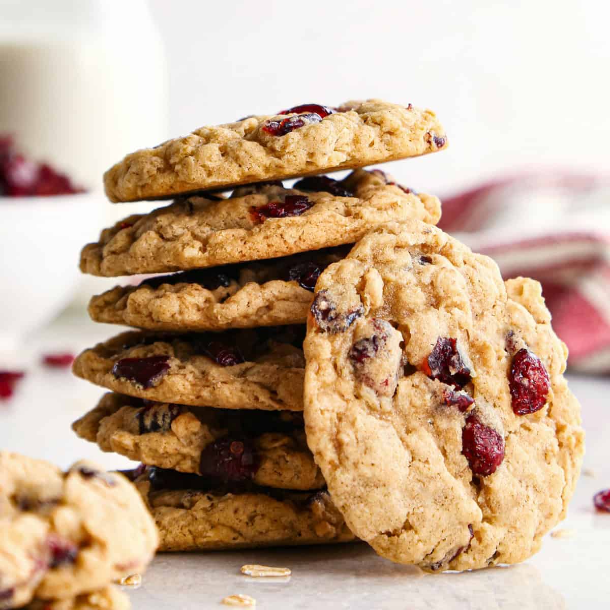 Close-up photo of a stack of cranberry oatmeal cookies on a countertop ready to serve.