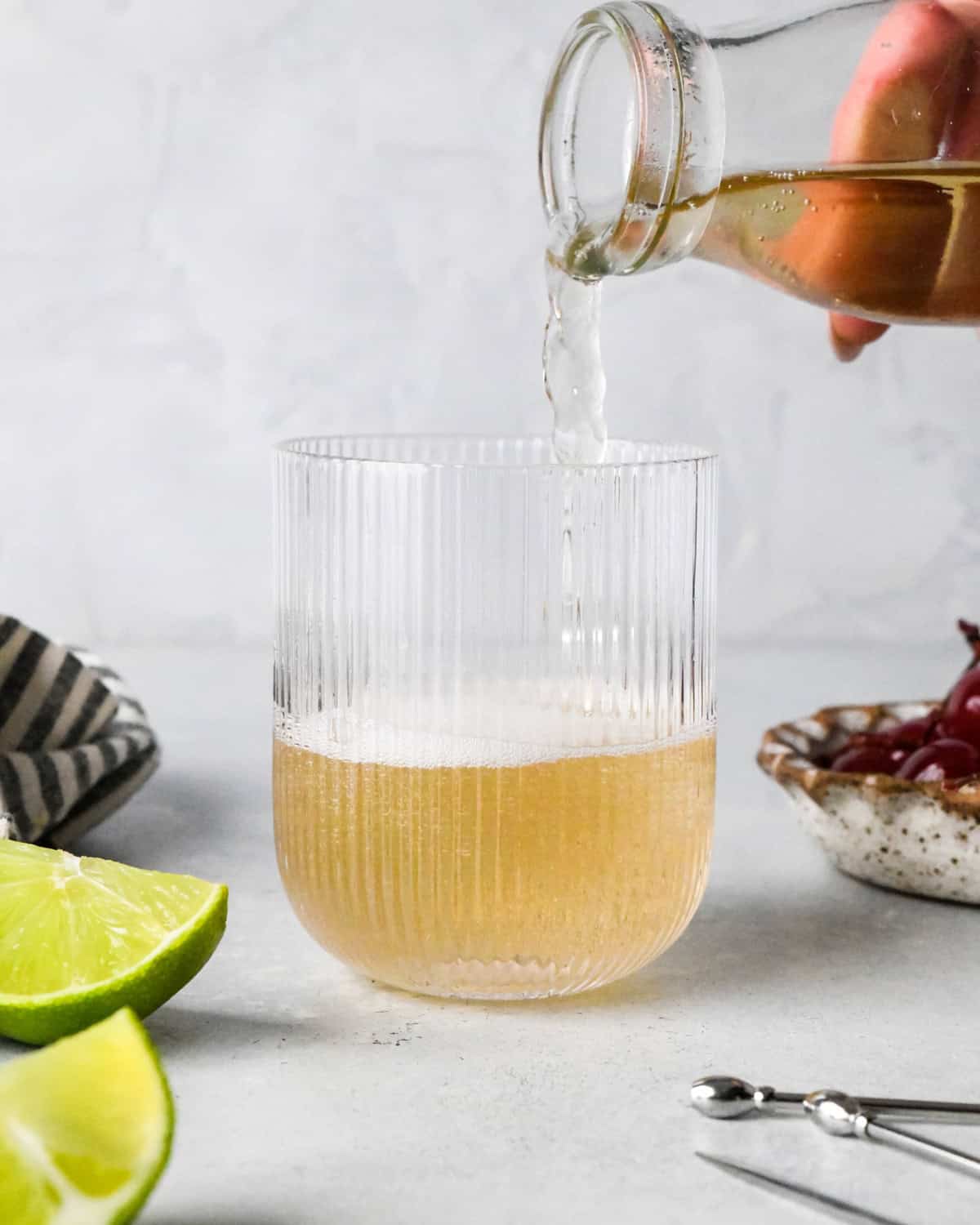 Making a Shirley Temple - close-up photo of ginger ale being poured into a clear glass.
