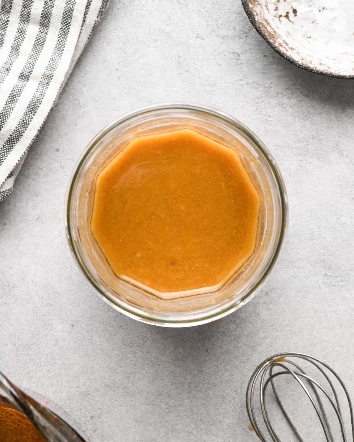 Making beef and broccoli: overview photo of sauce ingredients mixed together in a clear bowl.