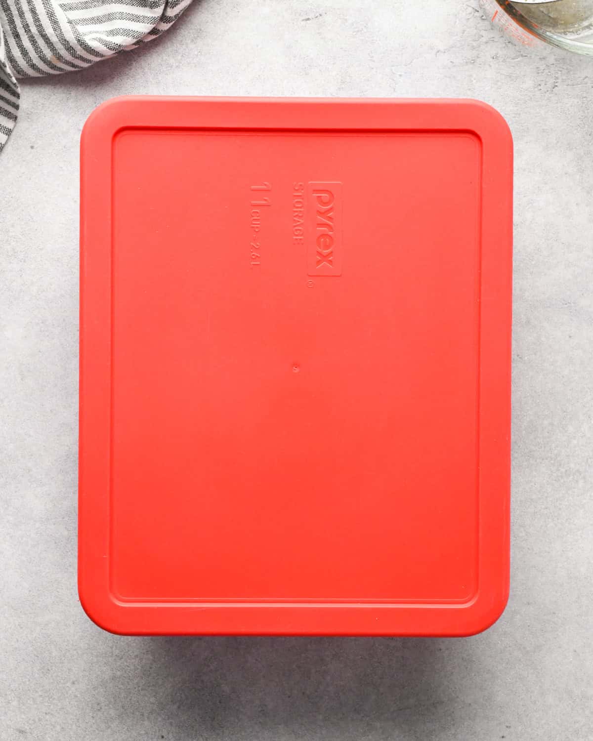 Making beef and broccoli: clear rectangle serving Pyrex dish is covered with a lid for marinating.