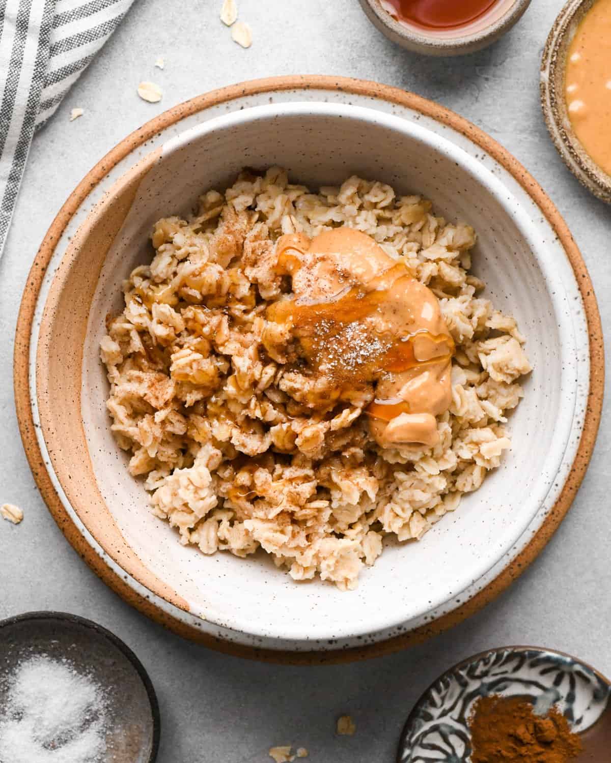 showing how to make oatmeal flavors - peanut butter and honey on top of cooked oatmeal in a bowl