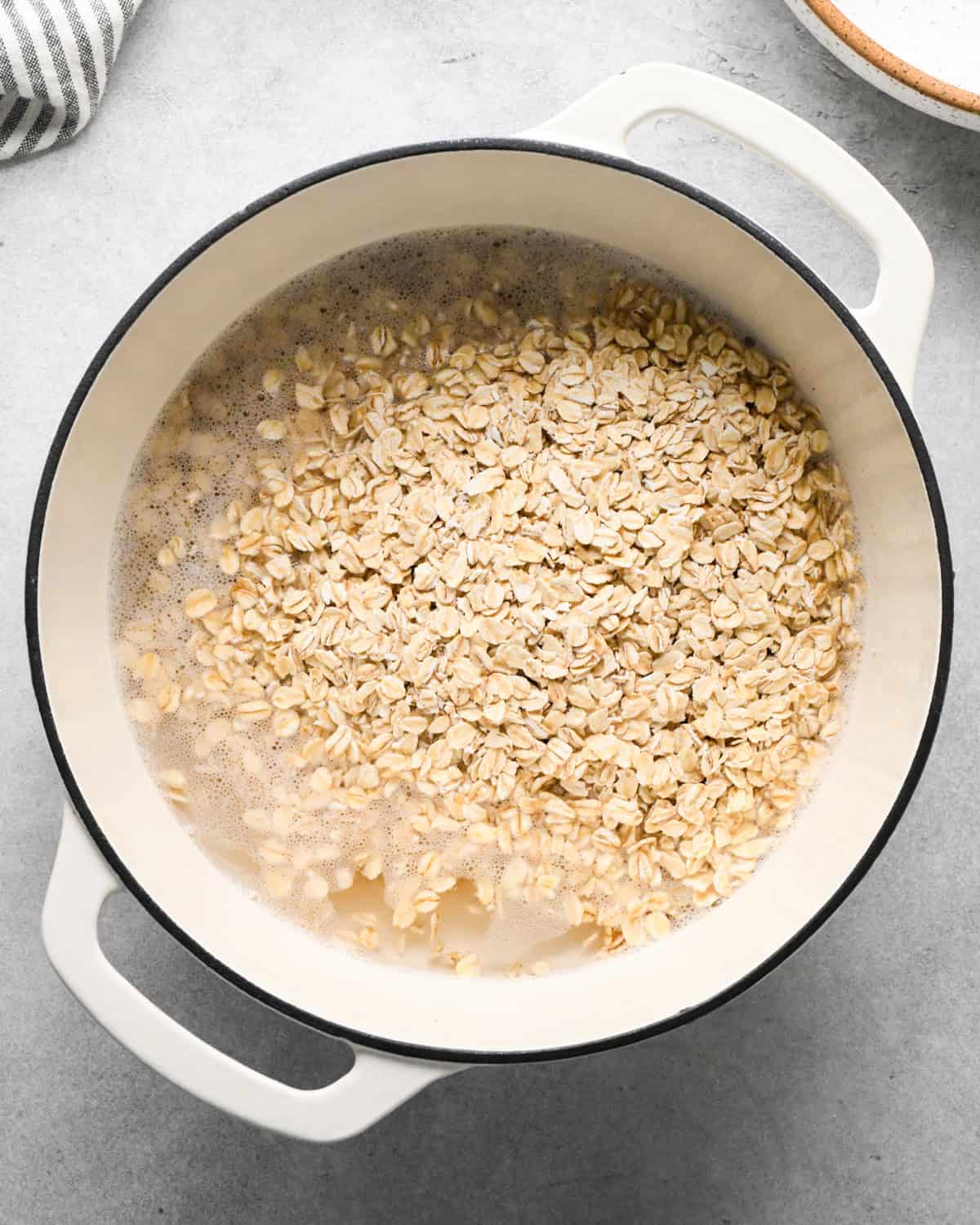 oatmeal and water in a pot showing how to make oatmeal