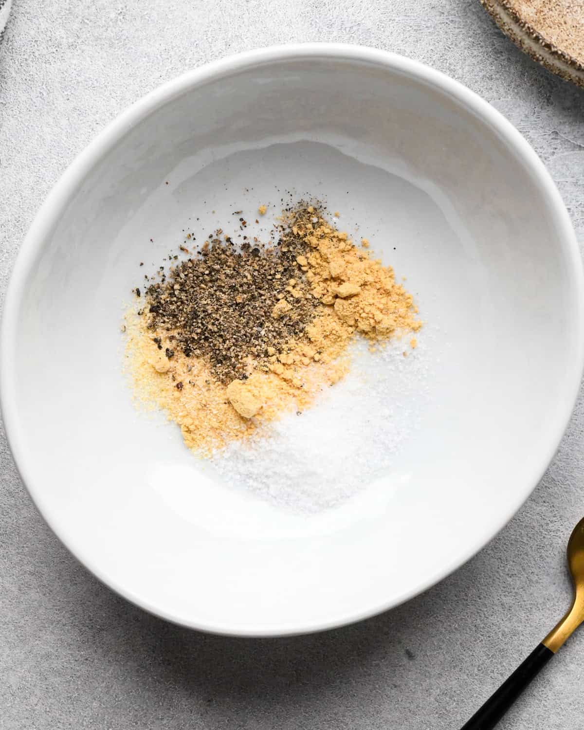Making chicken fried rice: overhead photo of a small white bowl of spices.