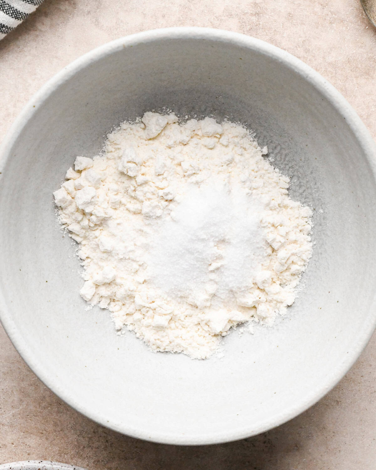 Making broccoli macaroni and cheese (mac and cheese): overhead photo of ingredients for homemade cheese sauce being added to a gray bowl.