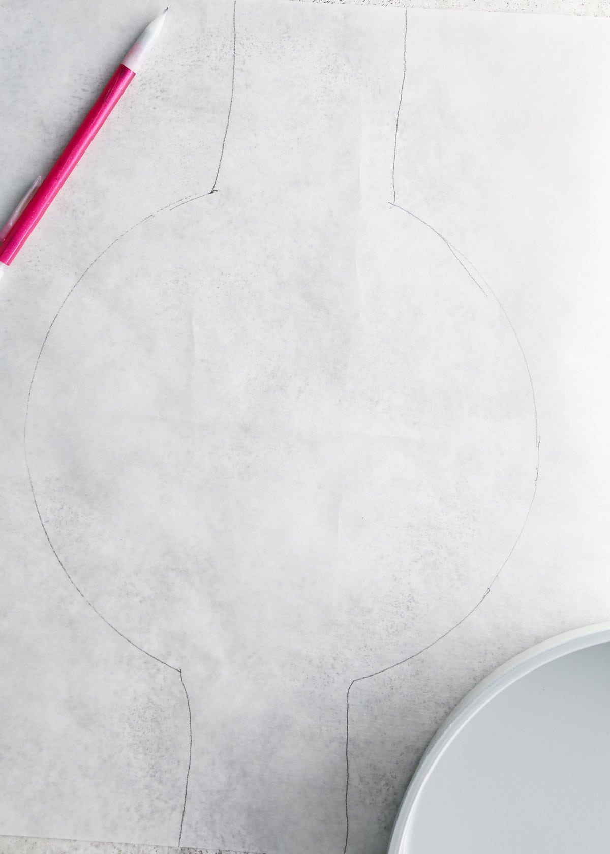 making chocolate olive oil cake - tracing the cake pan on a piece of parchment paper