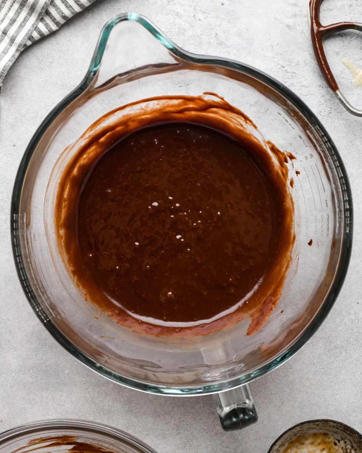 making cookie dough brownies - wet ingredients mixed together in a glass mixing bowl