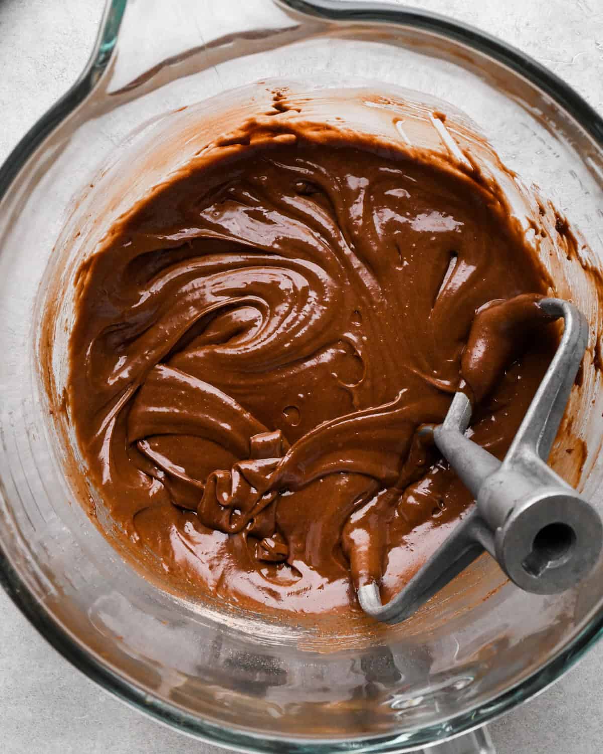 final cookie dough brownies batter in a glass mixing bowl with the paddle attachment int he batter