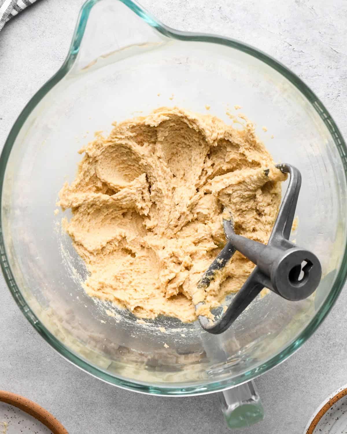 making cookie dough brownies - butter-sugars mixture in a glass mixing bowl after beating with the paddle attachment in the bowl