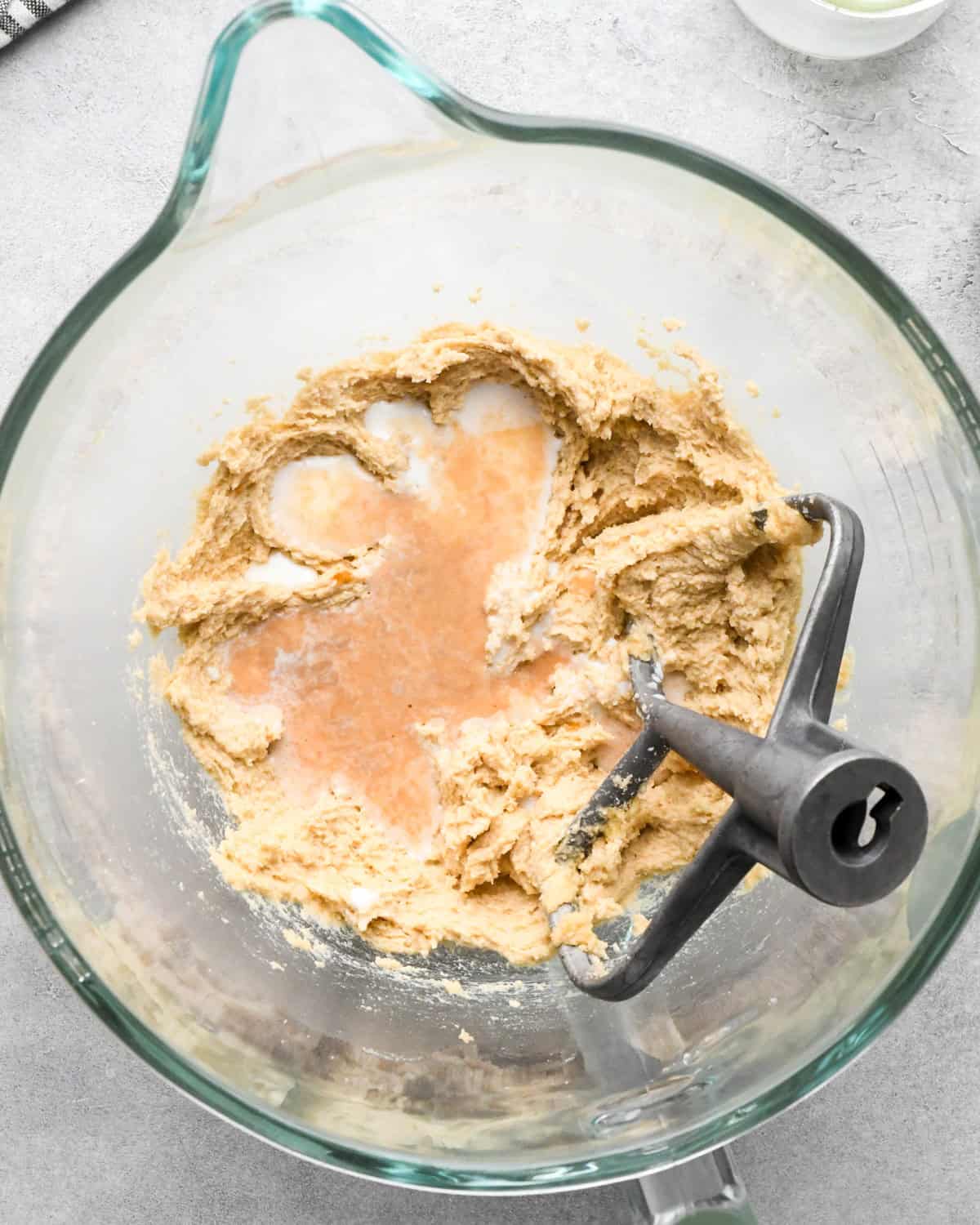 making cookie dough brownies - vanilla and milk added to the butter-sugars mixture before mixing in a glass mixing bowl with the paddle attachment in the bowl