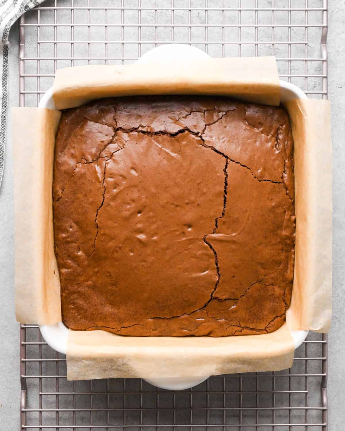brownies in a parchment lined baking dish after baking