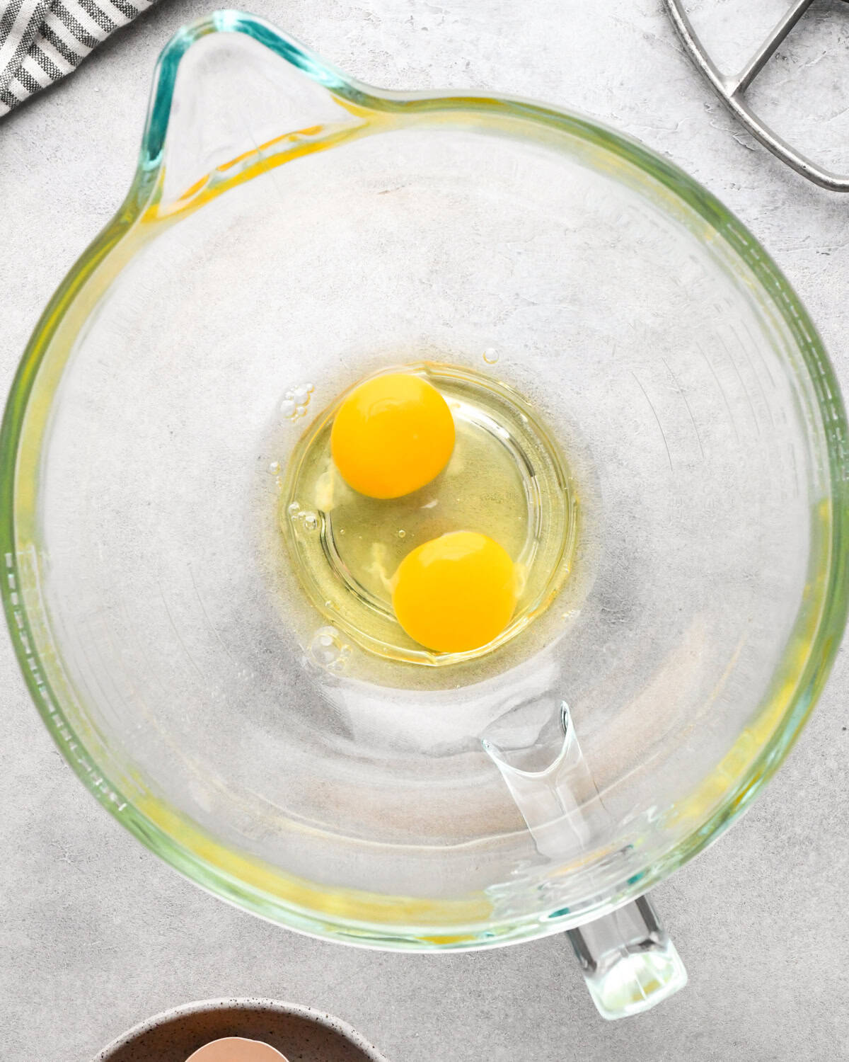 making cookie dough brownies - two eggs in a glass mixing bowl