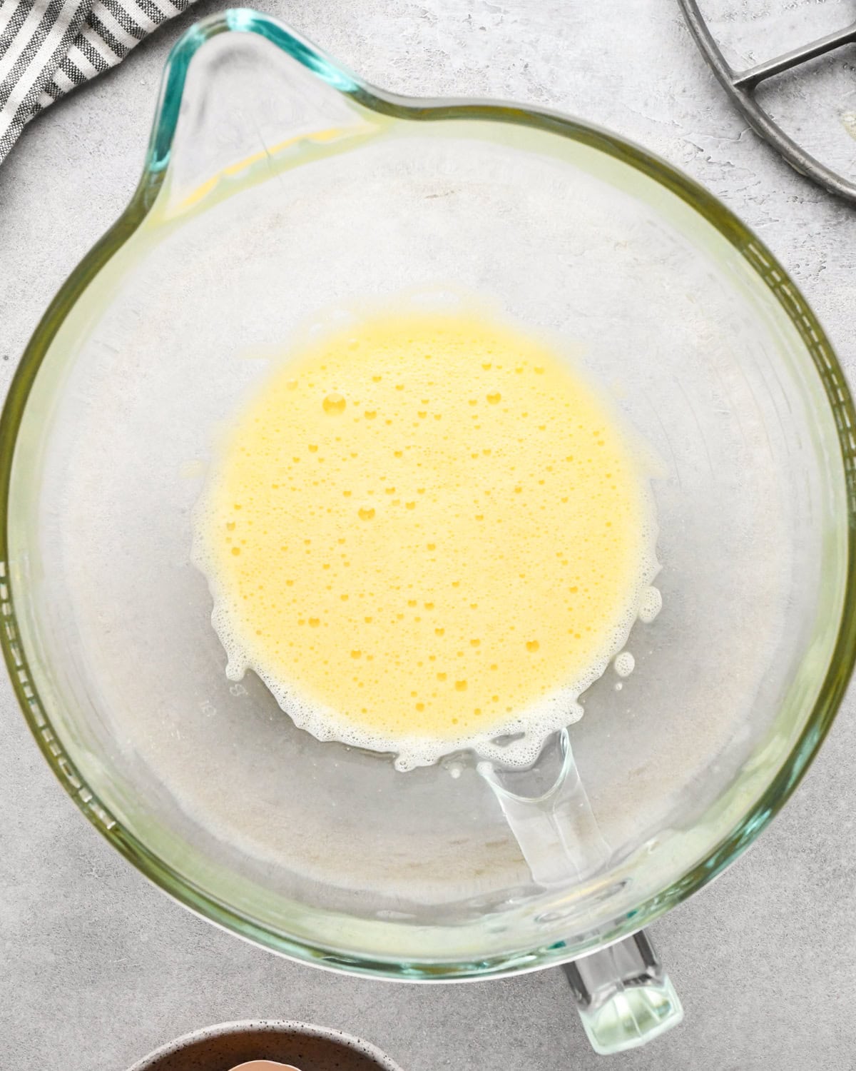 making cookie dough brownies - beaten eggs in a glass mixing bowl