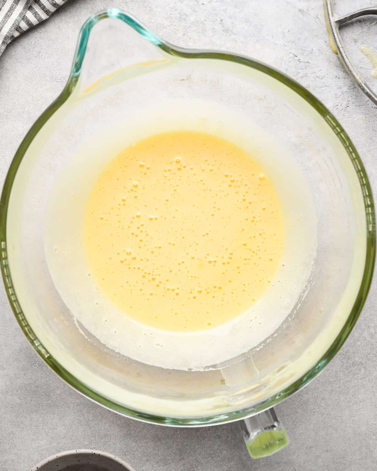 making cookie dough brownies - beaten eggs and sugar in a glass mixing bowl after mixing