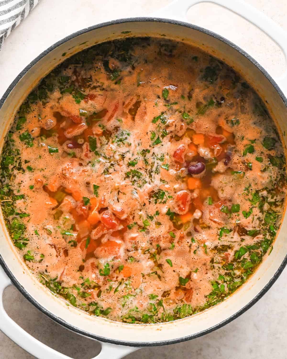 Making sausage tortellini soup: overhead photo of all ingredients stirred together in a large pot just before the tortellini is added.