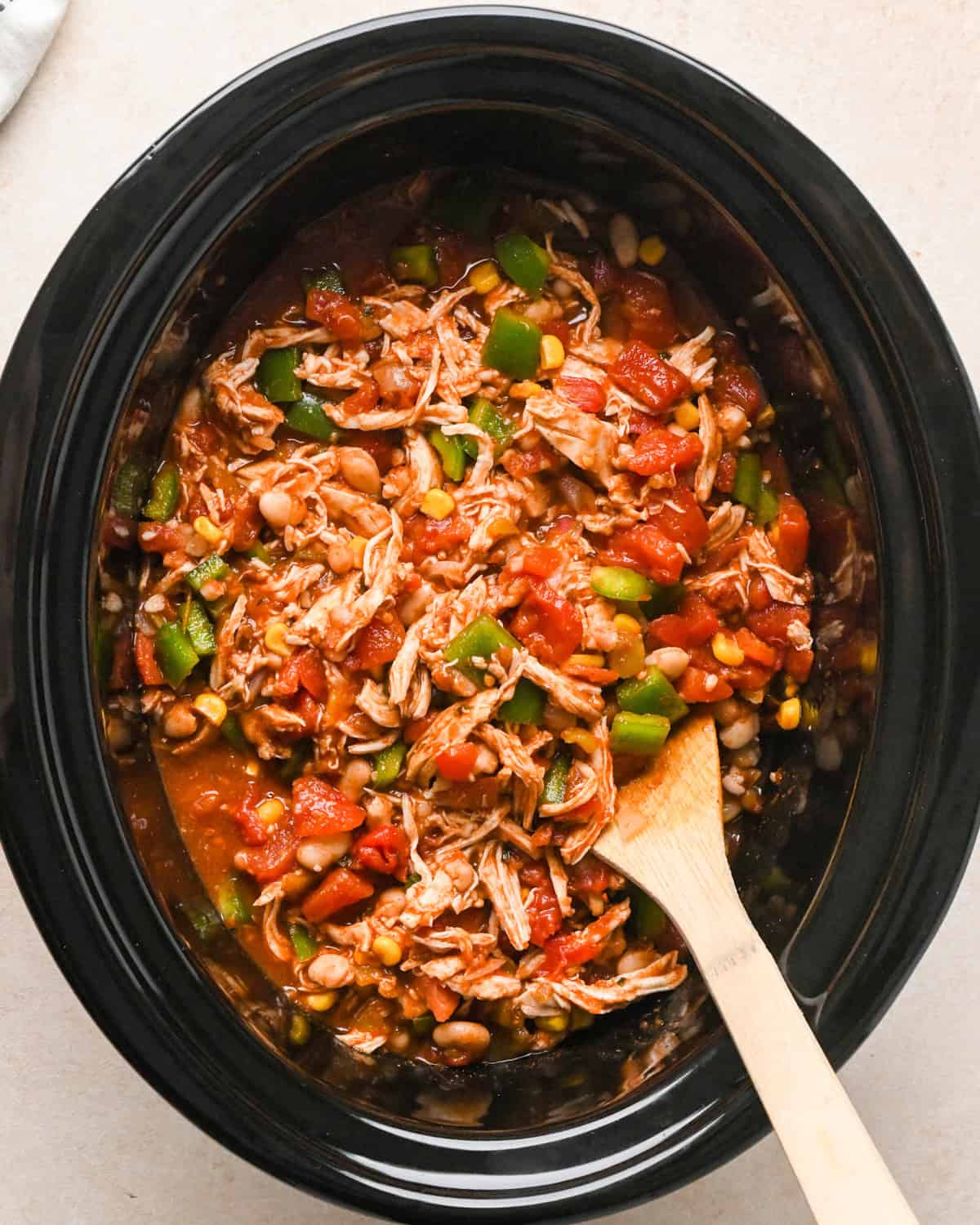 Slow Cooker Chicken Chili in a crock pot stirred before cooking