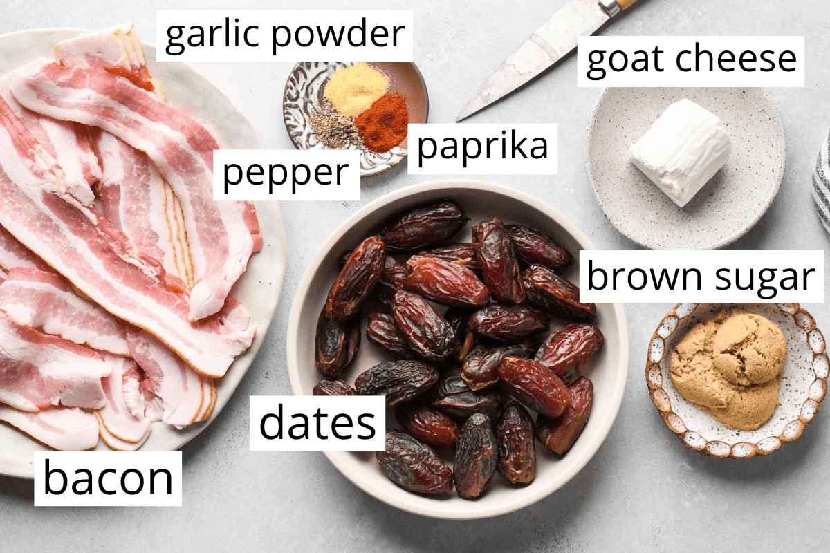 Overhead photo of the ingredients for bacon-wrapped dates including bacon, dates, brown sugar, garlic powder, pepper, paprika, and goat cheese.